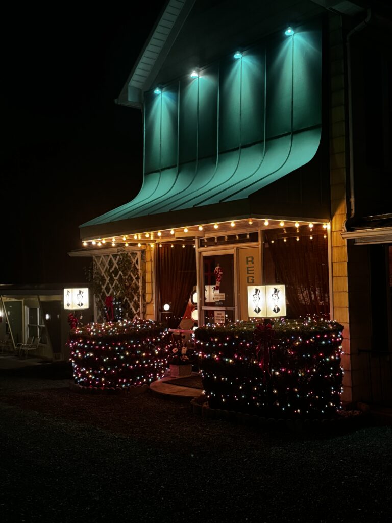 Koolwink Motel glowing with Christmas lights during the holiday season in Hampshire Highlands.